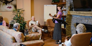 Musician entertaining residents in a group home